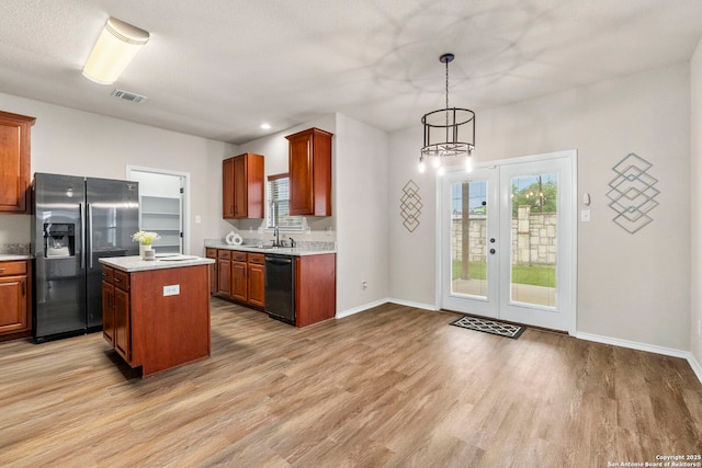 kitchen featuring plenty of natural light, a sink, dishwasher, and stainless steel fridge with ice dispenser