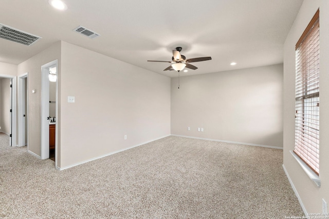 spare room with a ceiling fan, visible vents, recessed lighting, and carpet