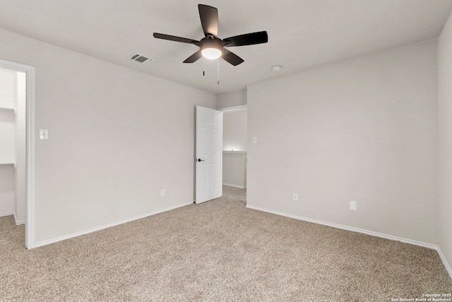 unfurnished bedroom with light colored carpet, baseboards, visible vents, and ceiling fan
