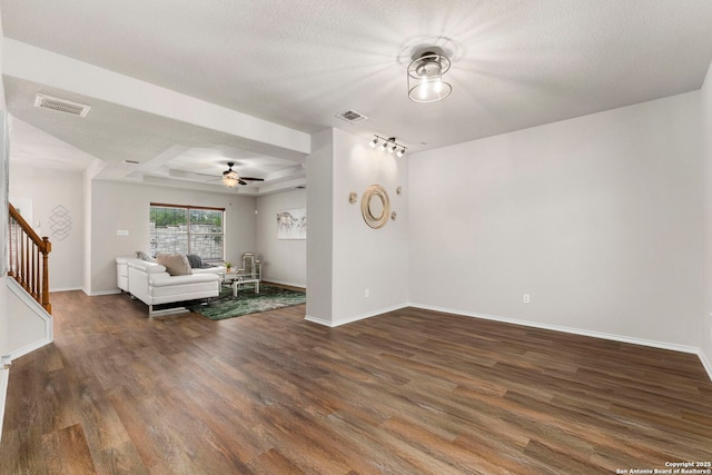 living area featuring stairway, ceiling fan, dark wood-style floors, and visible vents