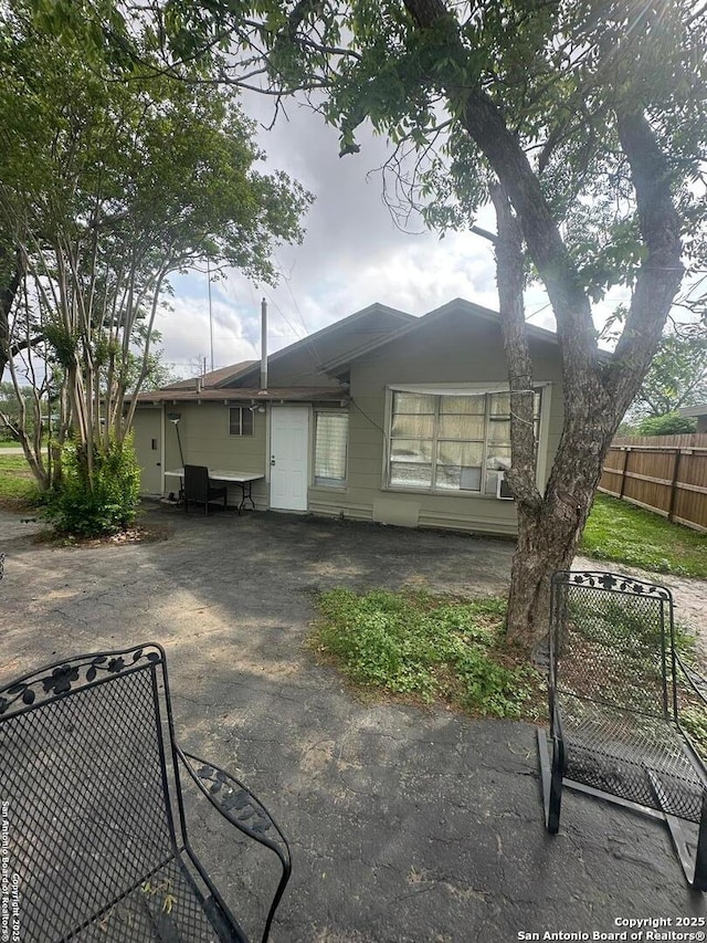 back of property with a patio and fence