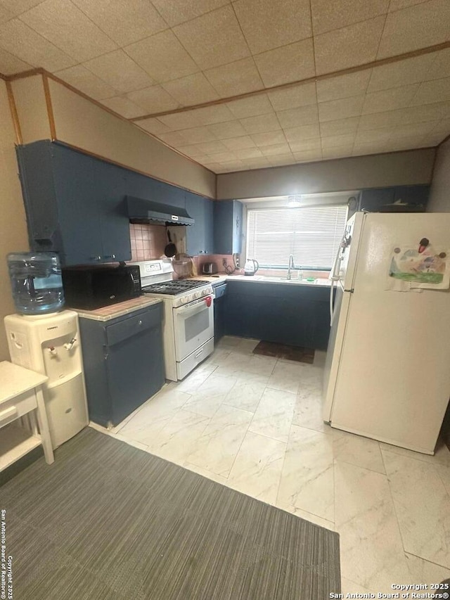 kitchen featuring white appliances and under cabinet range hood