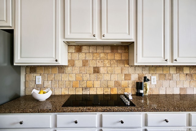 kitchen with white cabinets, dark countertops, and black electric stovetop