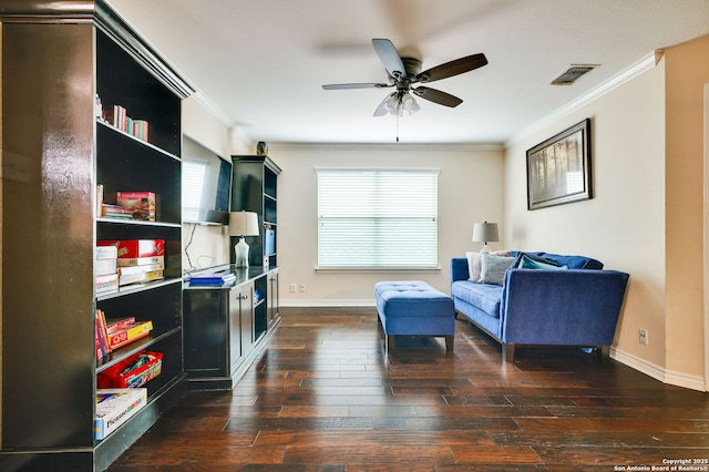 sitting room with plenty of natural light, ornamental molding, and hardwood / wood-style floors