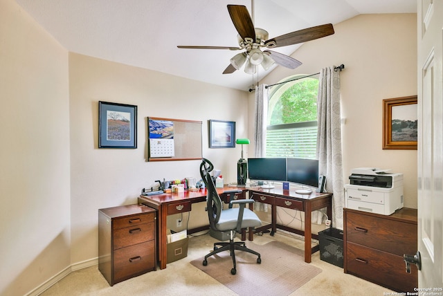 carpeted home office featuring baseboards, a ceiling fan, and vaulted ceiling