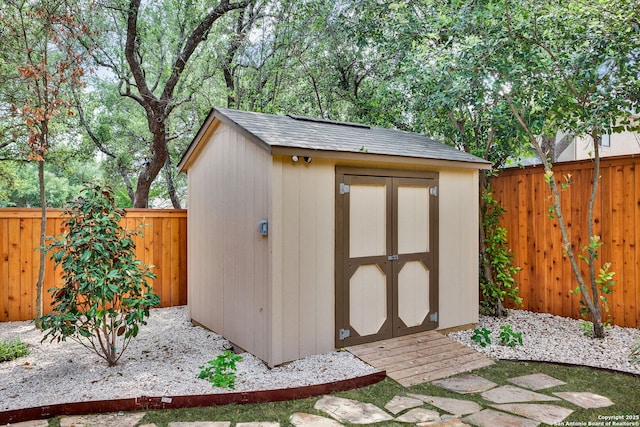 view of shed with a fenced backyard