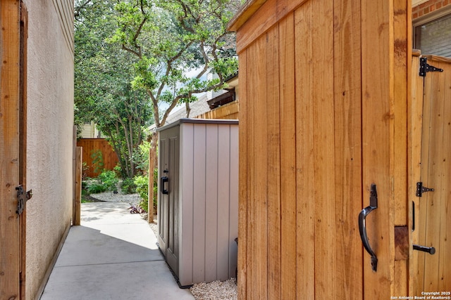 view of outbuilding featuring fence