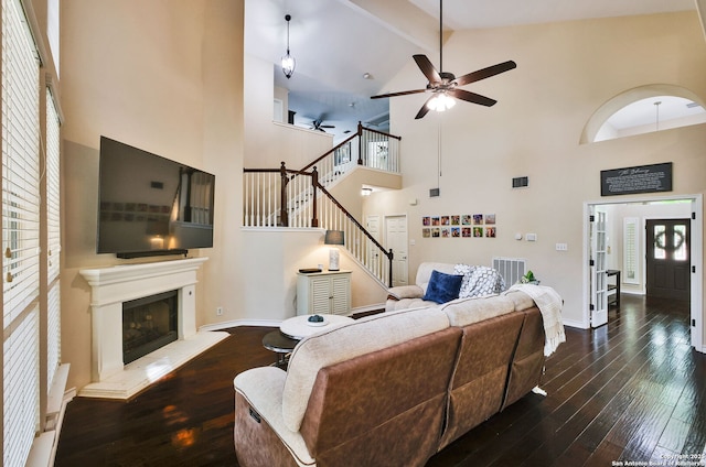 living area featuring high vaulted ceiling, ceiling fan, hardwood / wood-style floors, and visible vents