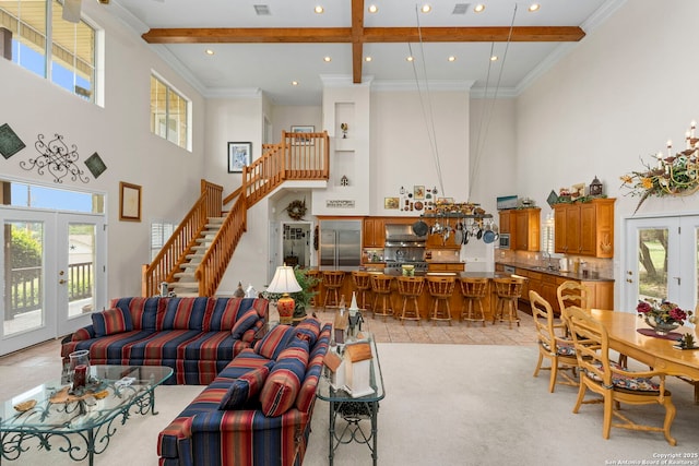 living area featuring beamed ceiling, recessed lighting, a towering ceiling, french doors, and stairs