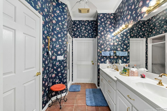 bathroom with ornamental molding, a shower stall, a sink, and wallpapered walls