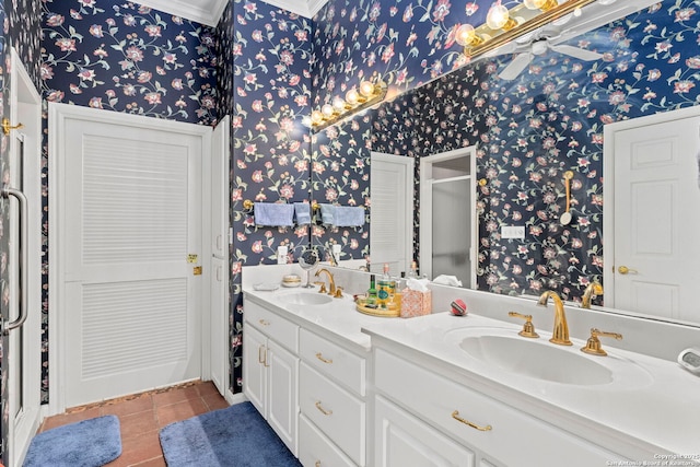 bathroom with double vanity, tile patterned flooring, wallpapered walls, and a sink