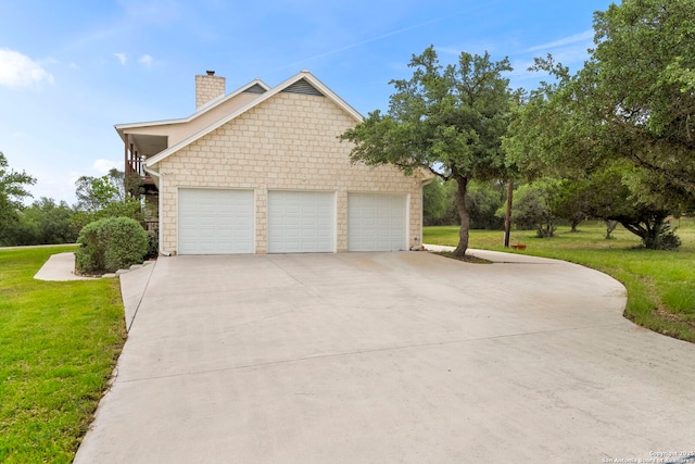 view of home's exterior with driveway, a chimney, a yard, and an attached garage
