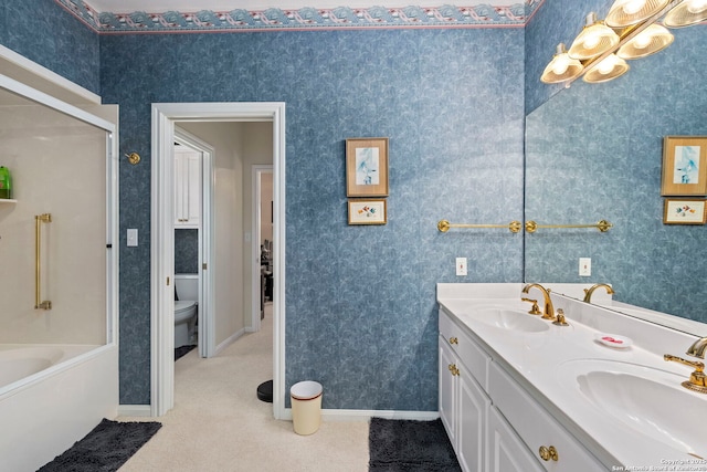 bathroom featuring a shower, toilet, double vanity, and a sink