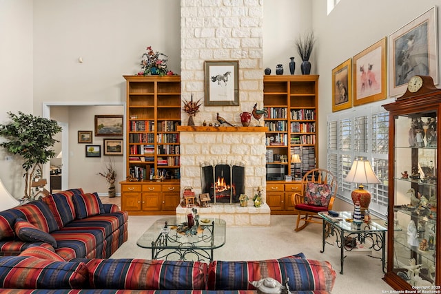 living area featuring a fireplace, a high ceiling, and carpet floors
