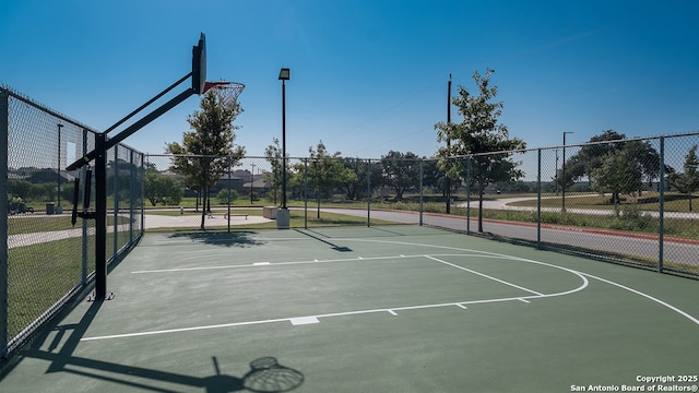 view of basketball court featuring fence and community basketball court