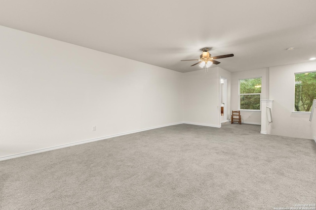 unfurnished room with baseboards, a ceiling fan, and carpet floors