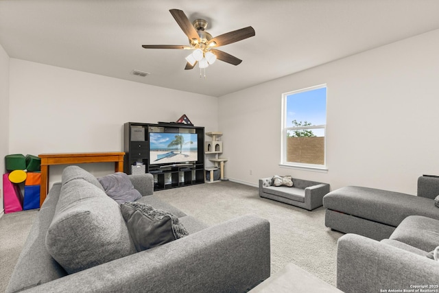 living area with visible vents, ceiling fan, carpet flooring, and baseboards