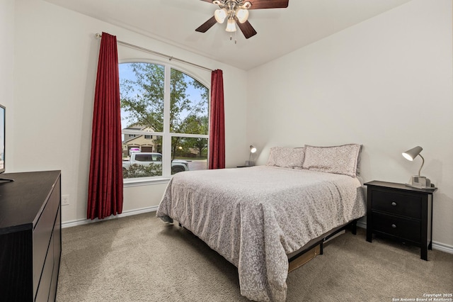 bedroom with ceiling fan, baseboards, and carpet floors