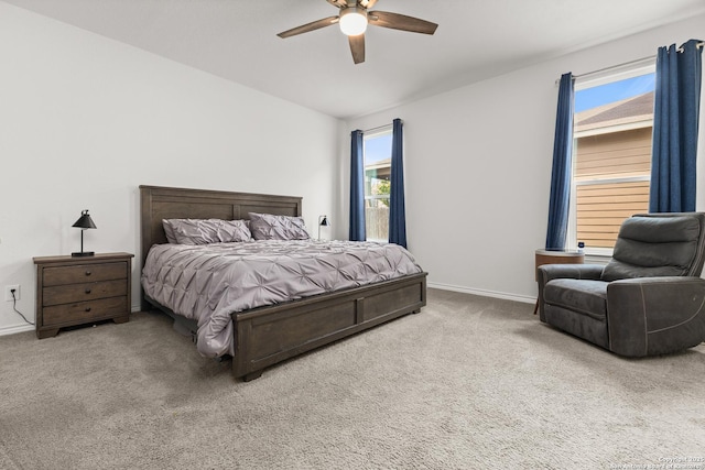 carpeted bedroom with ceiling fan and baseboards