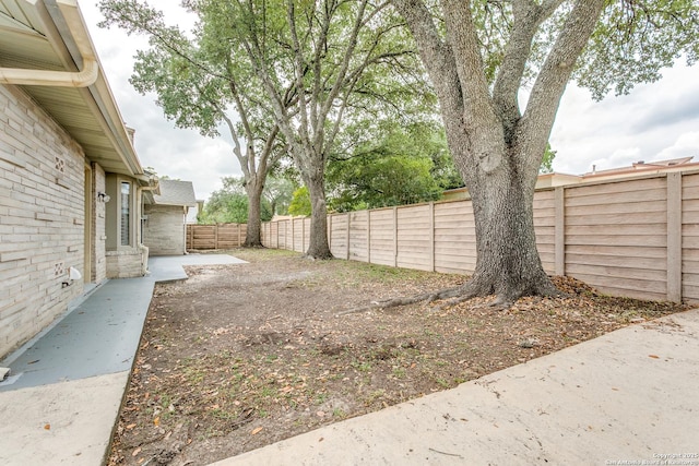view of yard with a patio and a fenced backyard