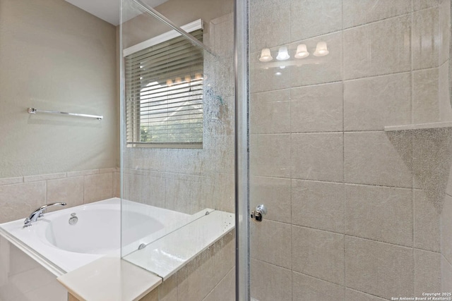 bathroom with a garden tub and a shower stall