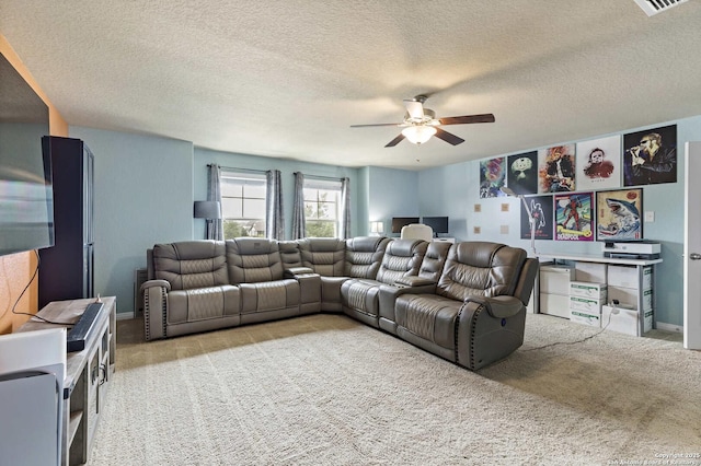 carpeted living area featuring a textured ceiling, ceiling fan, visible vents, and baseboards