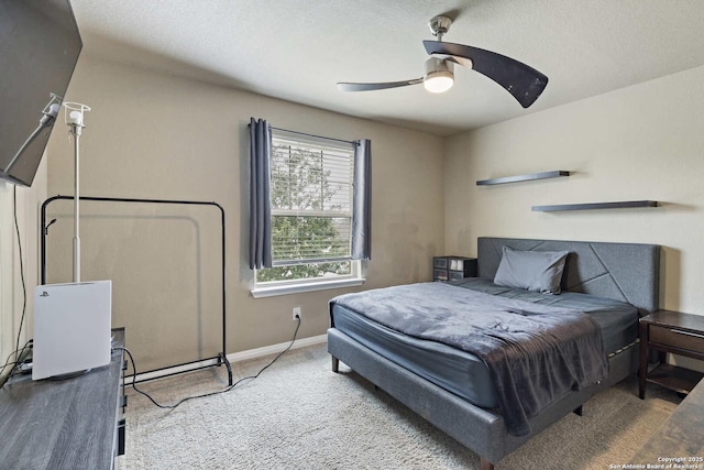 bedroom with baseboards, a ceiling fan, and carpet