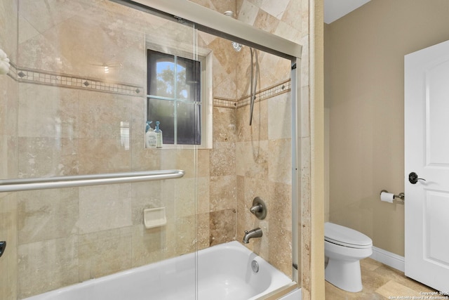 full bath featuring toilet, enclosed tub / shower combo, and baseboards