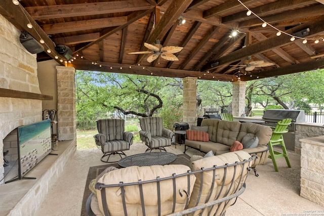 view of patio featuring a gazebo, area for grilling, outdoor lounge area, an outdoor kitchen, and a ceiling fan