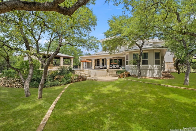 back of house with a gazebo, a yard, and a patio area