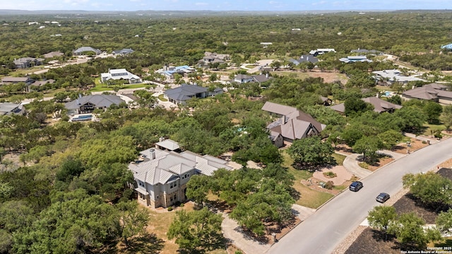 birds eye view of property with a forest view and a residential view