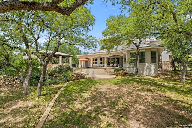 back of house featuring a gazebo and a patio area