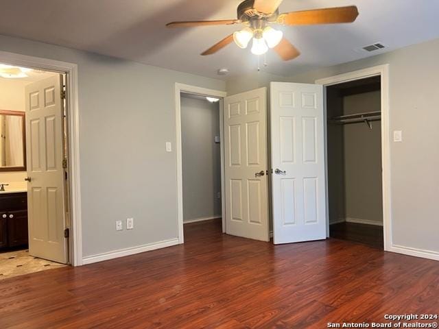 116 N Matlock, Poth, TX 78147 - unfurnished bedroom featuring a closet, visible vents, wood finished floors, and baseboards
