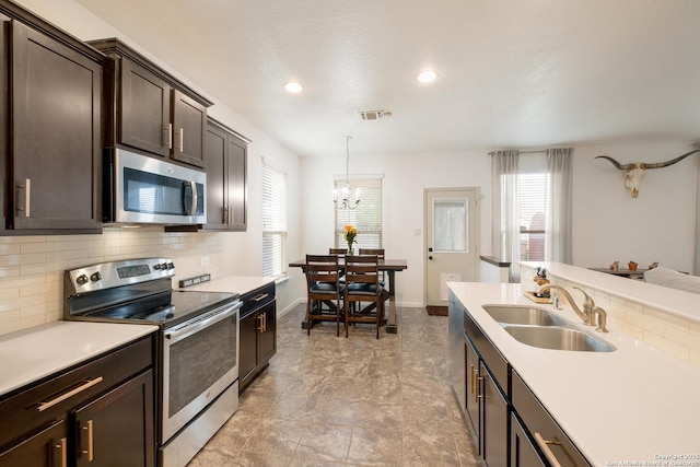 kitchen with appliances with stainless steel finishes, visible vents, a healthy amount of sunlight, and a sink