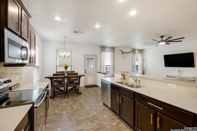 kitchen featuring a sink, dark brown cabinets, appliances with stainless steel finishes, and tasteful backsplash