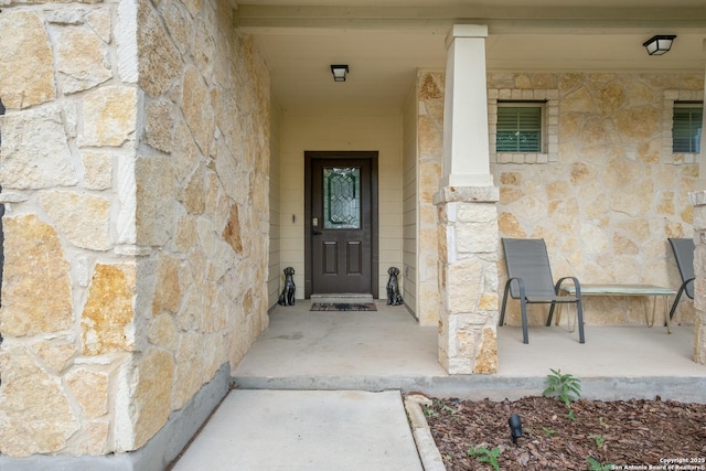 doorway to property featuring stone siding
