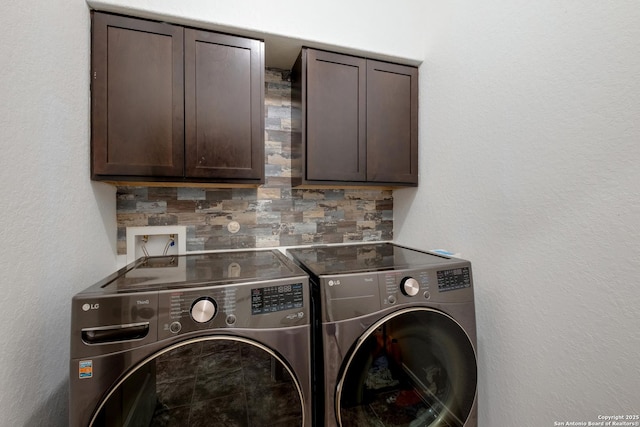 washroom featuring separate washer and dryer and cabinet space