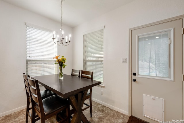 dining space with a notable chandelier and baseboards