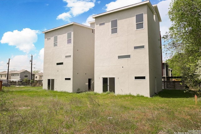back of house with fence and stucco siding