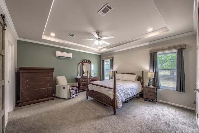carpeted bedroom with visible vents, a wall mounted air conditioner, a tray ceiling, and crown molding
