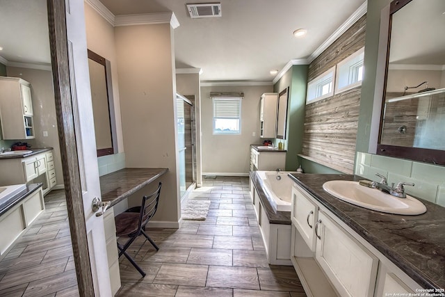 full bathroom with a sink, crown molding, visible vents, and a shower stall