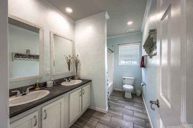 full bathroom featuring crown molding, toilet, a sink, and washtub / shower combination