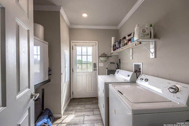 laundry room with light wood-type flooring, crown molding, laundry area, and washing machine and dryer
