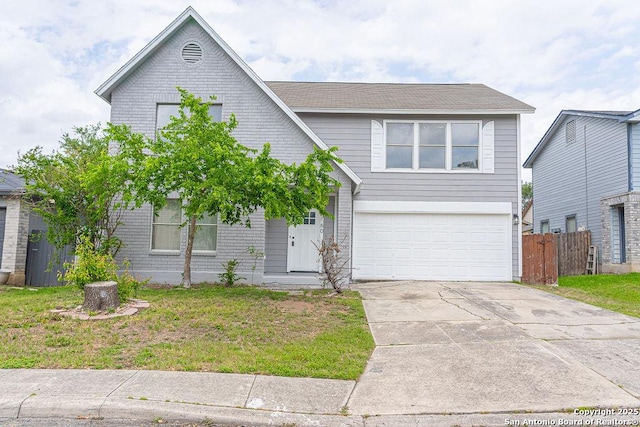 view of front of property featuring a front yard, driveway, a garage, and fence