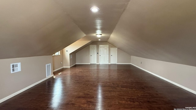 7274 Fm 327, Elmendorf, TX 78112 - bonus room with lofted ceiling, dark wood-type flooring, visible vents, and baseboards