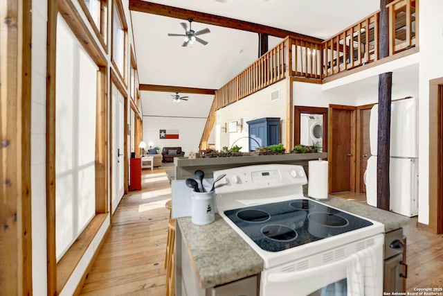 kitchen featuring fridge, electric stove, light wood-style floors, high vaulted ceiling, and a ceiling fan