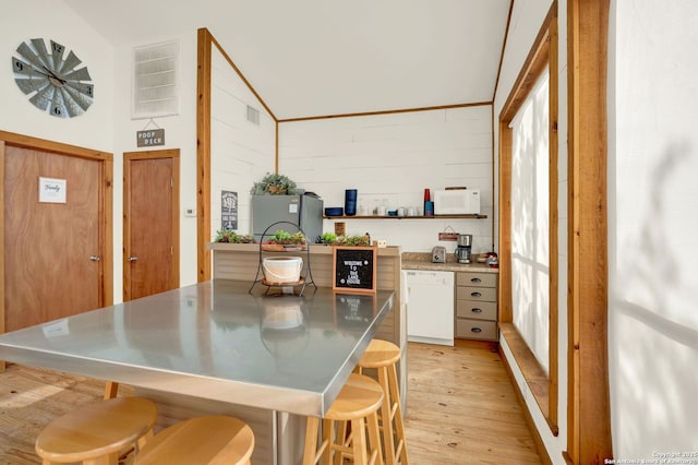 kitchen featuring stainless steel counters, light wood finished floors, open shelves, visible vents, and white appliances
