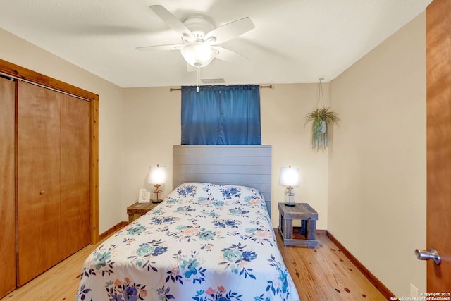 bedroom with a closet, ceiling fan, baseboards, and light wood-type flooring