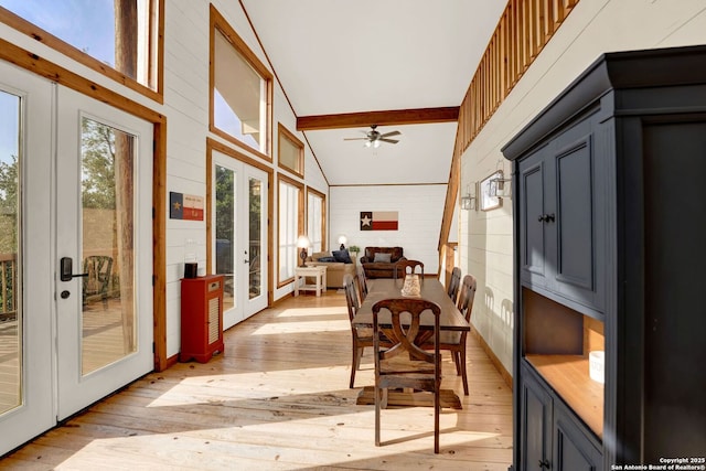 sunroom / solarium featuring beam ceiling and french doors