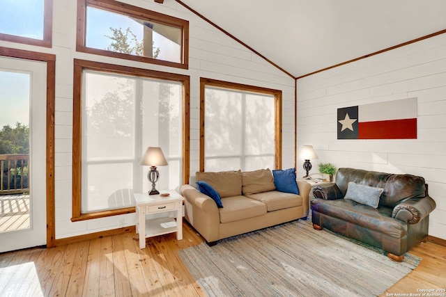 living room with wood walls, lofted ceiling, and wood-type flooring